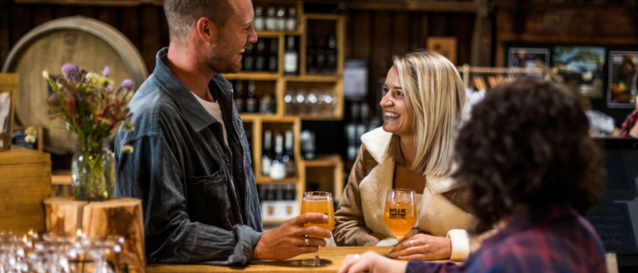 Guests enjoy glasses of cider at the bar inside Willie Smith’s Apple Shed.